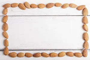 Vegetarian Meal Idea Prints: Rectangular frame made from almonds on white wooden background