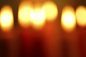 Candlelight Glow Prints: Red burning candles, unsharp in the background