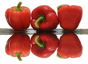 Deserted Studio Still Life Prints: Three red capsicums, with reflection
