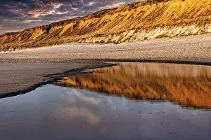 Steep Coast Germany Prints: Red cliff reflected in the water
