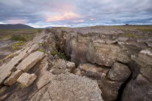 Atmospheric Landscape Photography Prints: Red column in the plain with dramatic clouds in the evening sky in the fault zone