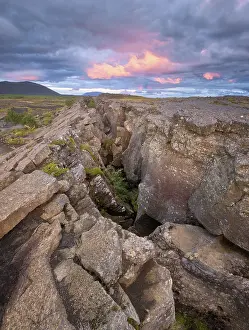 Dramatic Evening Sky Prints: Red column in the plain with dramatic clouds in the evening sky in the fault zone