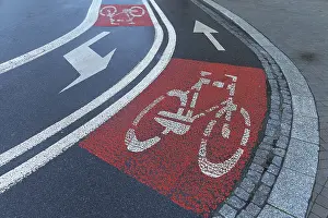 Cycle Path Markings Prints: Red marked bicycle paths on the roadway