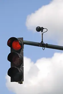 Overcast Sky Photography Prints: Red traffic light with sensor against cloudy sky