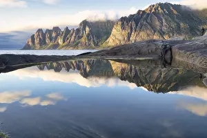 Northern Norway Scenery Prints: Reflections of clouds, rocks and the Devil's Tooth mountain in the evening sunlight