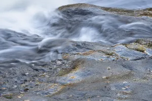 Lapland Sweden Prints: Reflections on a rock at a rushing stream
