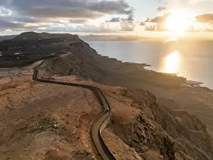 Rocky Shoreline At Sunset Prints: Road on cliffs in evening light