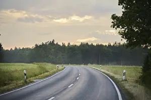 Southern Germany Weather Forecast Prints: Road through fields and forests at sunset after rain