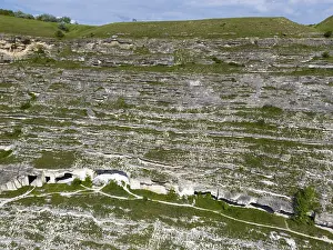 Prints of Rock formations with visible caves covered by grass and vegetation, aerial view, cave dwellings, Old Orhei, Orheiul Vechi, archaeological site, protected landscape area, Orhei district Moldova Prints: Rock Formations with Cave Dwellings Print, Moldova