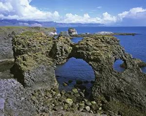 Volcanic Island Landscape Prints: Rock gate at the cliffs formed by volcanic basalt columns in Arnarstapi