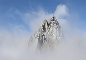 Cloudy Mountain Range Prints: Rocky mountain peak between clouds