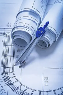 Architecture Design Prints: Rolls of blueprints and drawing compass construction concept