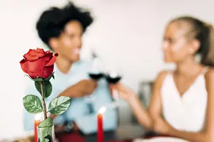 Passionate Love Affair Prints: A romantic dinner setting featuring a red rose in focus