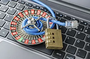Secure Internet Connection Prints: Roulette wheel, padlock and internet cable lying on computer keyboard symbolizing data encryption