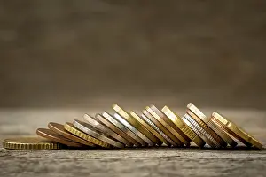 Capital Market Image Prints: Row of various coins lie on the table