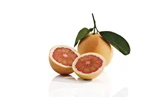 Studio Shot Fruits Prints: Ruby Red grapefruit with stem and leaves