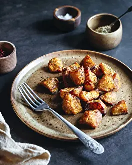 Dark Table Setting Prints: A rustic ceramic plate filled with crispy