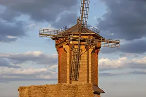 Evening Sun Setting Prints: A rustic windmill is illuminated by sunset