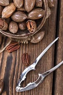 Shallow Depth Of Field Nuts Prints: Rustic wooden table with some Pecan Nuts (selective focus)