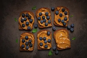 Fresh Blueberries On Rye Bread Prints: Rye bread with peanut paste and fresh blueberries