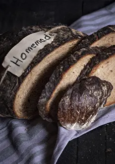 Appetizing Food Photos Prints: Rye bread sliced on a wooden table