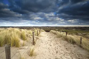 European Seaside Resort Prints: Sand path to dunes and cloudy sky