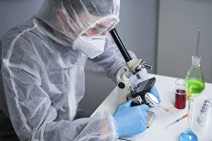 Healthcare System Professional Prints: Scientist examining sample with a microscope