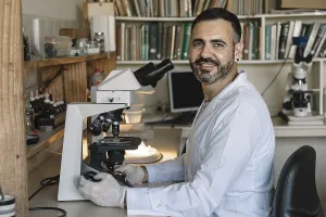 Young Researcher Prints: Scientist in front of microscope