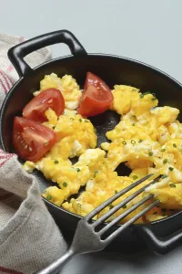 Chicken Egg Nutrition Facts Prints: Scrambled eggs with tomatoes in a pan
