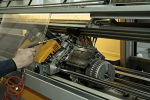 Factory Production Line Prints: Serviceman setting up the knitting machine close up cropped view