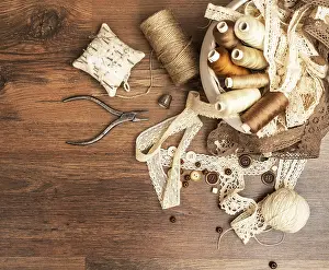 Female Tailor Prints: Sewing concept. Thread spools, buttons and sewing needles