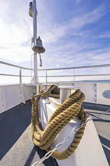 Boat Trip Europe Prints: A ship deck with thick ropes and a bell