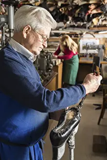 Handcrafted Shoes Europe Prints: Shoemaker, man pulling nails with pliers out of last