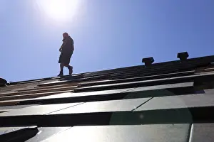 Handicraft Roofer At Work Prints: Silhouette of a roofer against the light