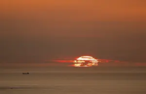 Norway Sunset Prints: Silhouette of a ship in front of the setting sun