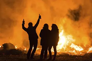Central Europe Celebrations Prints: Silhouettes of three people at an Easter fire