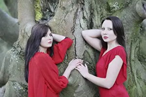 Young Sisters Prints: Two sisters in front of an old tree