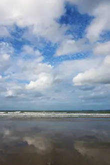 Cloudy Sky Reflection Prints: Sky and clouds are reflected on the surface of a calm beach
