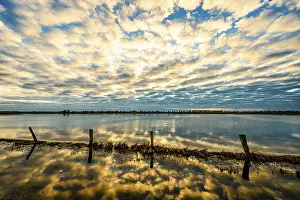 Peaceful Evening Sky Prints: Sky with dramatic clouds is reflected in calm water at sunset