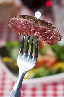 Food Photography Still Life Prints: Slice of steak on a fork over salad