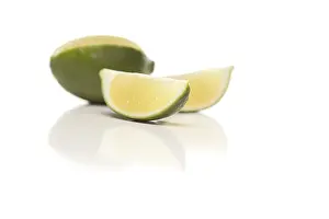 Food Cutout Images Prints: Sliced lime on a reflective white surface