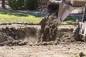 Bulldozer Construction Site Prints: Small bulldozer digging in yard for pool installation