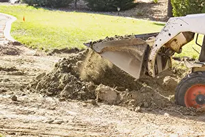 Bulldozer Construction Site Prints: Small bulldozer digging in yard for pool installation