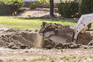 Bulldozer Construction Site Prints: Small bulldozer digging in yard for pool installation
