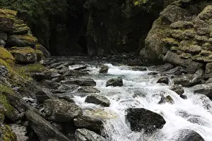 Deserted Waterfall Prints: Small waterfall flows out of a dark cave