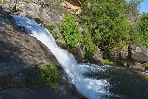 Cascada Del Diablo Spain Prints: A small waterfall flows over large rocks