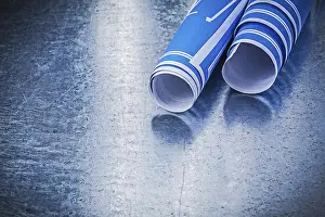 Blue Construction Plans Prints: Stack of blue construction plans on metallic background building concept