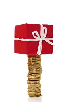 Christmas Present Ideas Prints: Stack of coins with gift parcel, present on top
