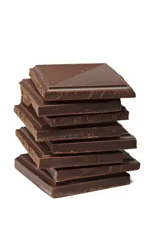 Studio Shot Of Candy Prints: Stack of dark chocolate isolated on white