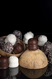 Dark Chocolate Kisses Prints: Stack of different chocolate kisses on a dark background